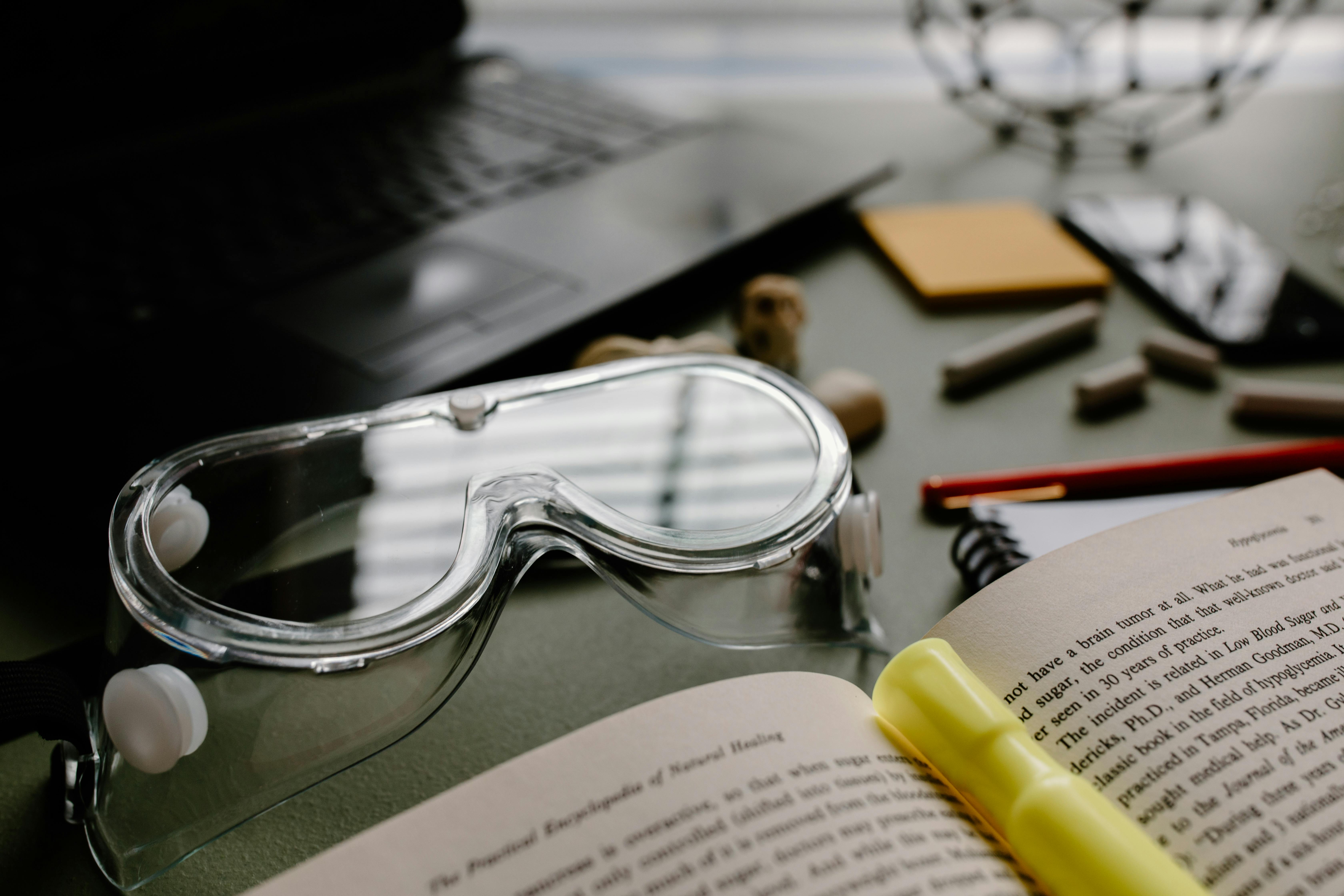 silver framed eyeglasses on black laptop computer