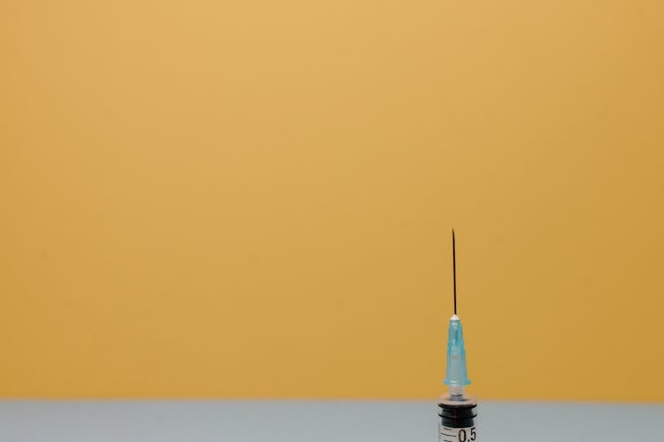 A Close-Up Shot Of The Needle Of A Syringe