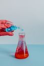 Putting Blue Liquid in a Beaker