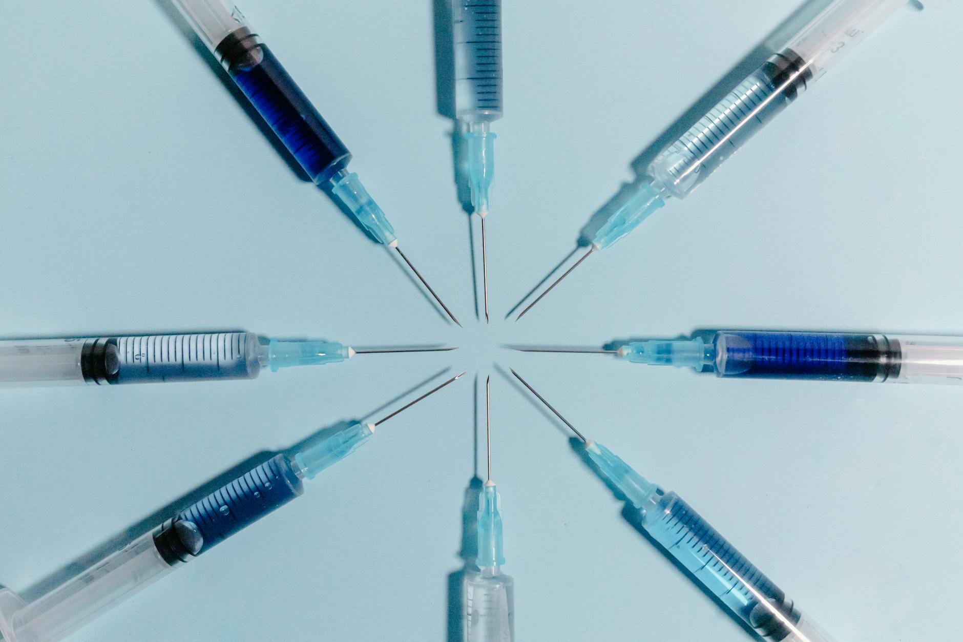 https://www.pexels.com/photo/close-up-shot-of-syringes-on-a-blue-surface-7723188/
