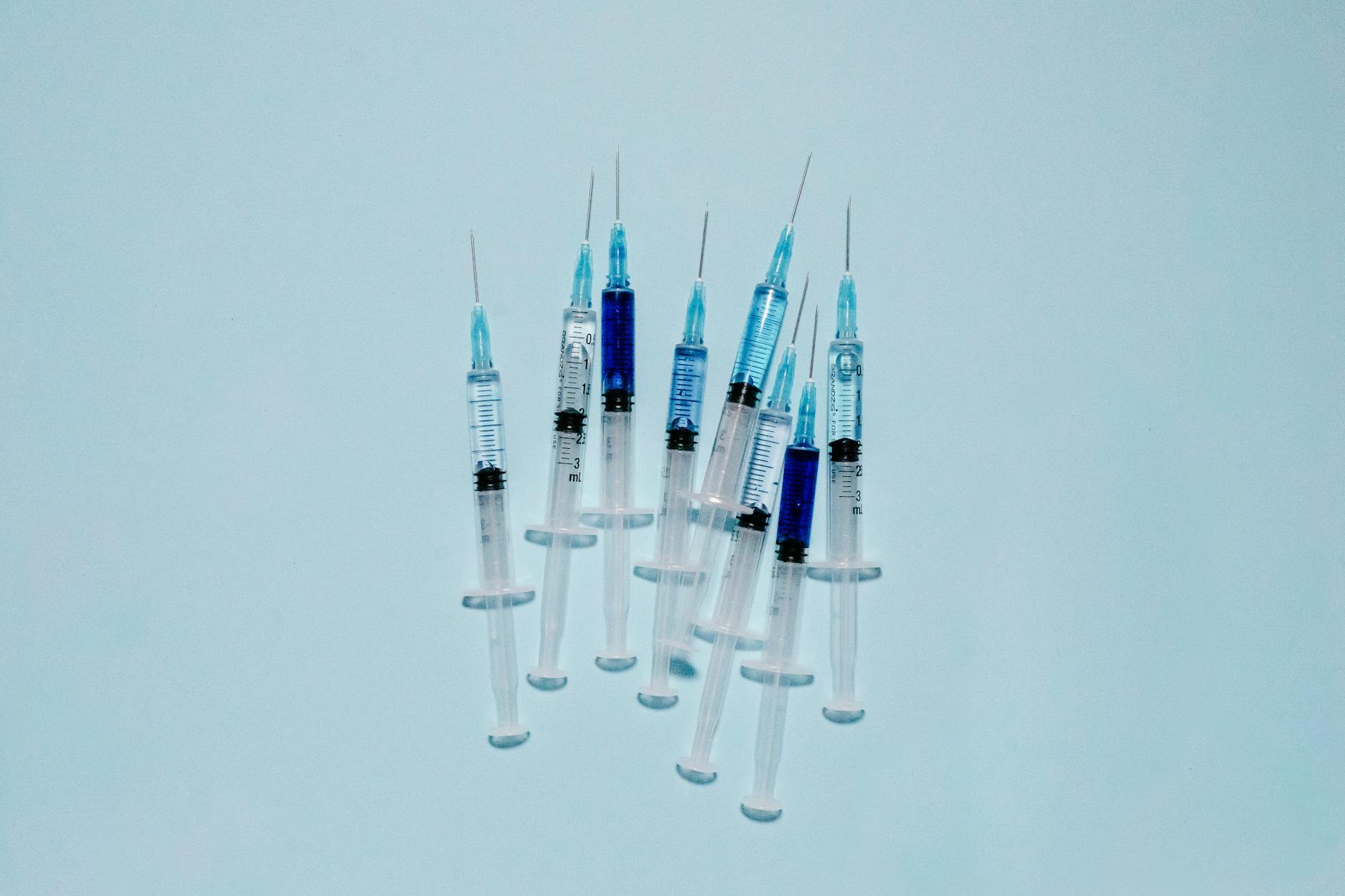 A cluster of medical syringes with blue fluid, ideal for healthcare and vaccination themes.