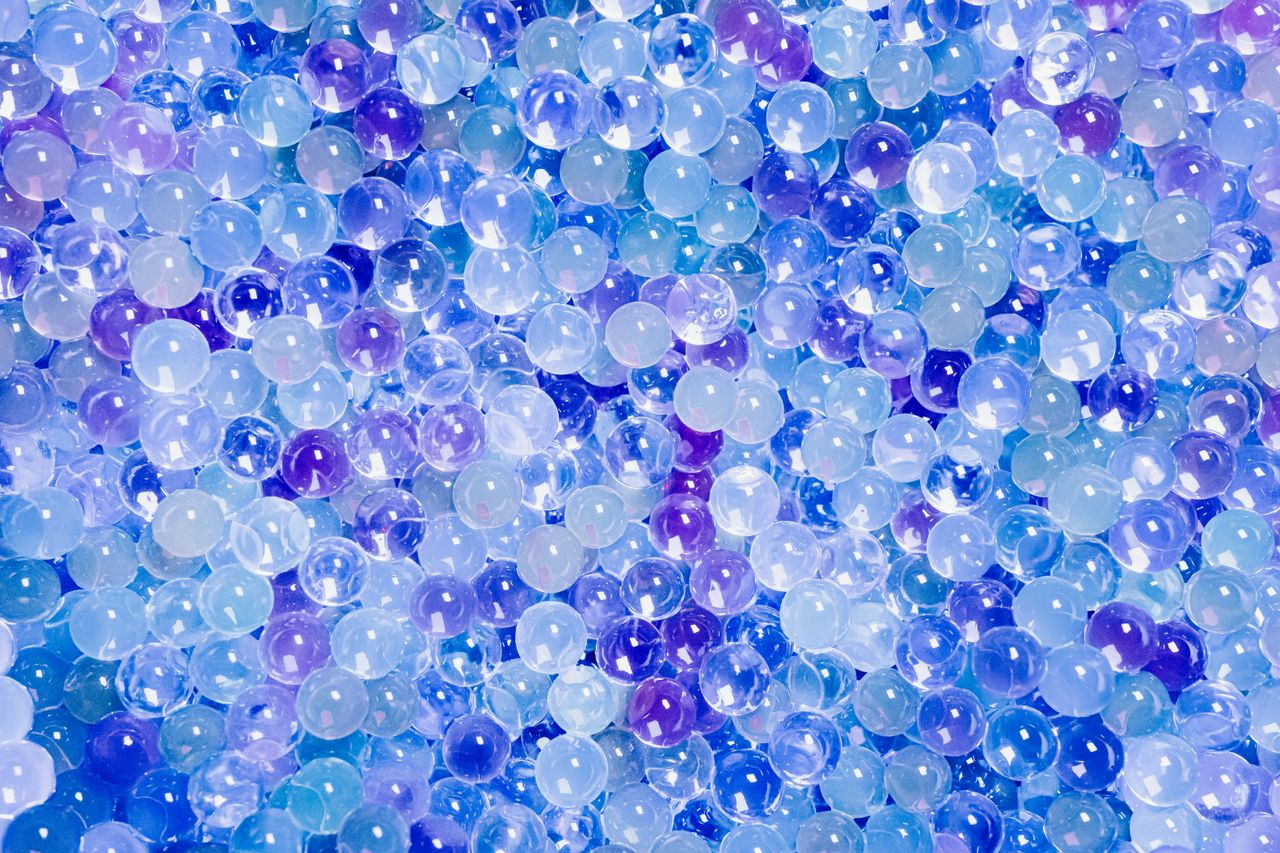 a stunning collection of blue and purple translucent beads creating a