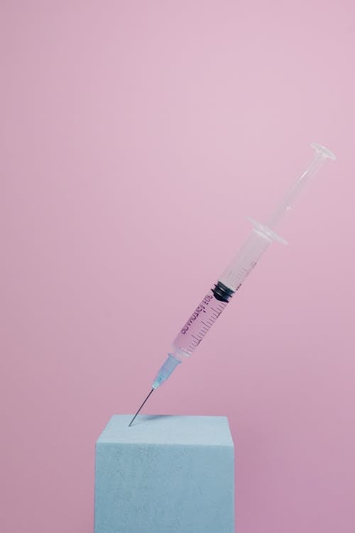 Free A Syringe in Pink Background Stock Photo