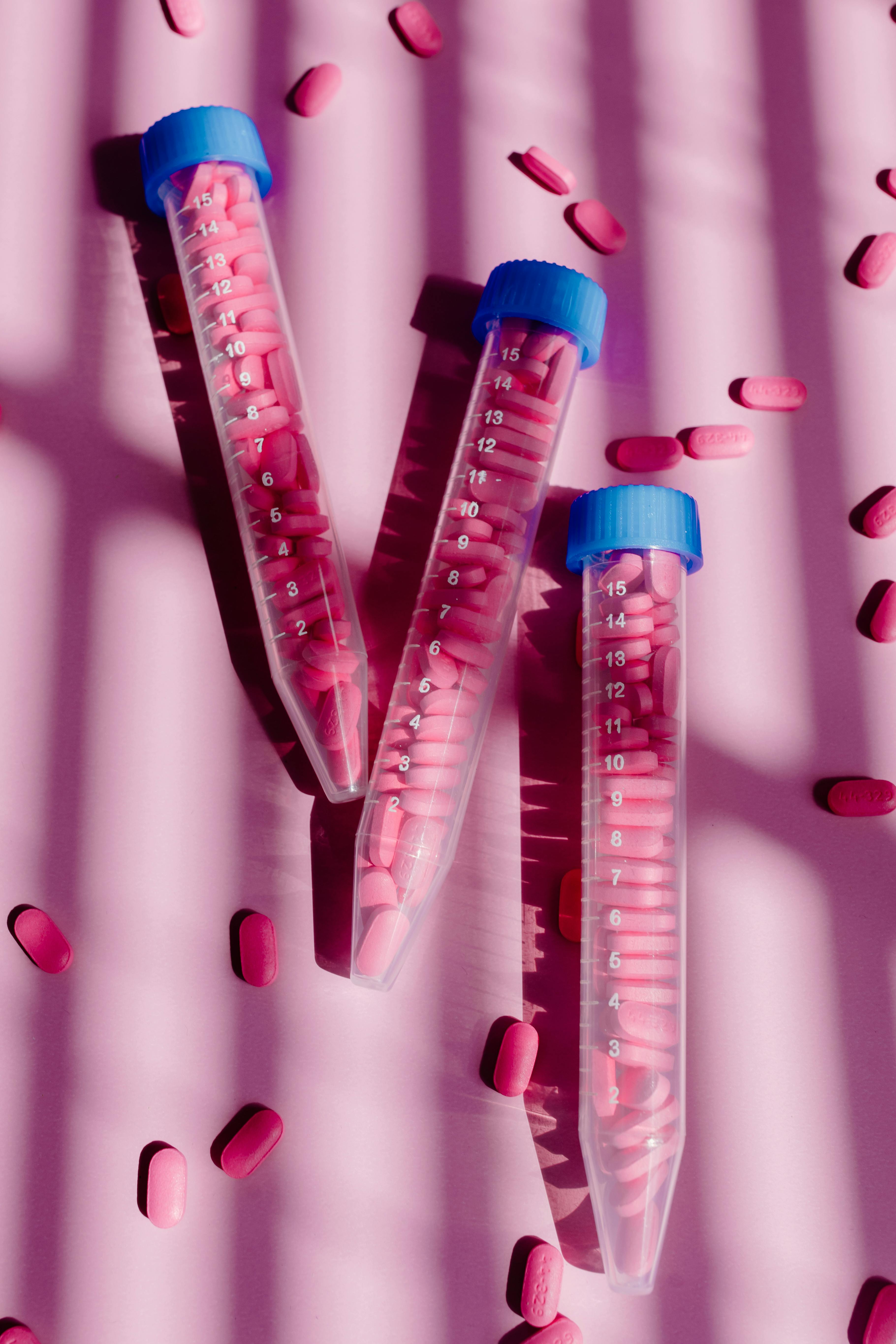 plastic tubes filled with pink tablets