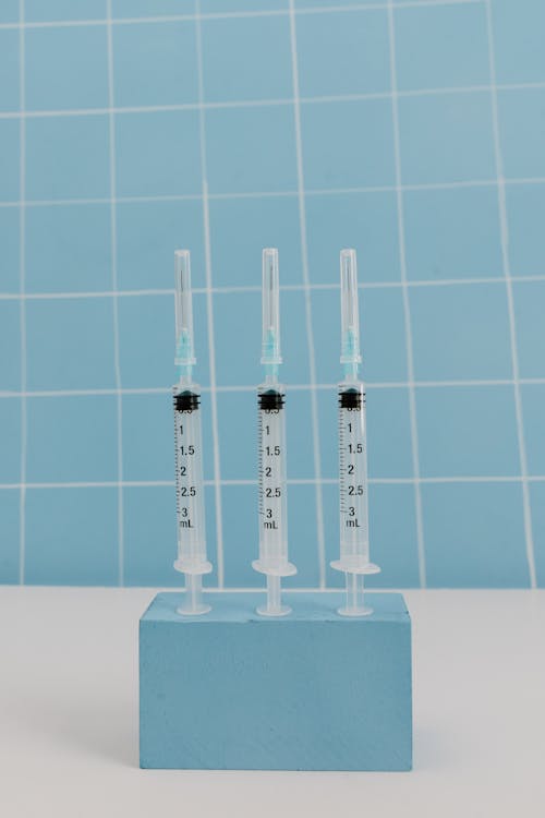 Syringes on Top of Blue Block