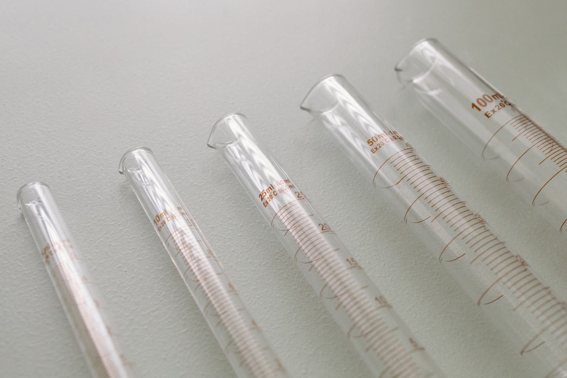 A detailed close-up of graduated cylinders used for precise measurements in laboratories.