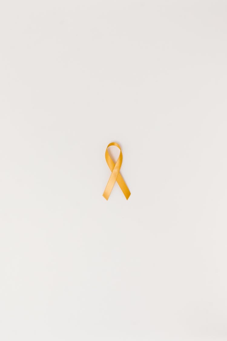 A Yellow Ribbon On A White Surface