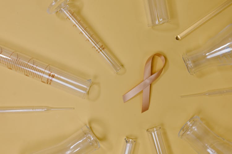 Ribbon Representing Breast Cancer Amidst Test Tubes