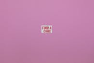 A Find a Cure on White Paper Posted on Purple Background