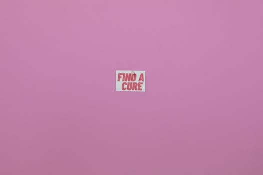 Minimalistic pink background with 'Find a Cure' message. Perfect for health awareness campaigns.