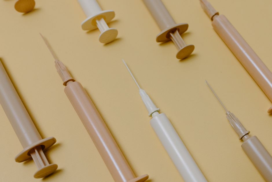 Arrangement of multicolor syringes creates a striking abstract composition.