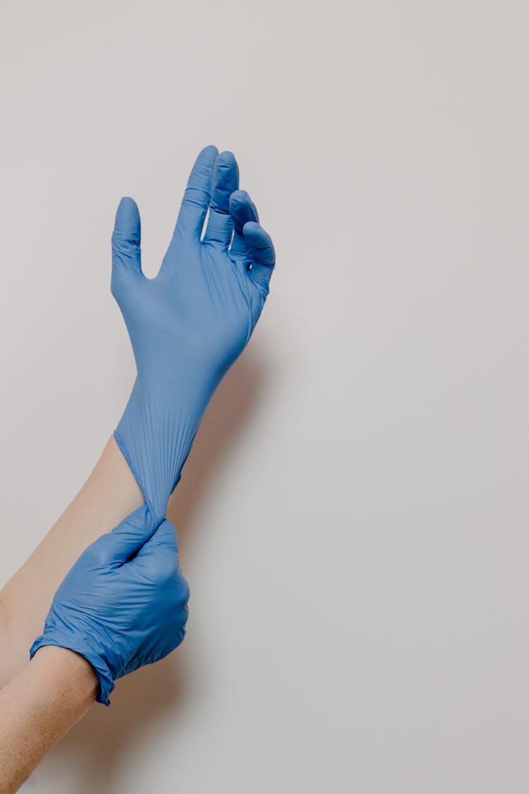 A Person Wearing Blue Surgical Gloves