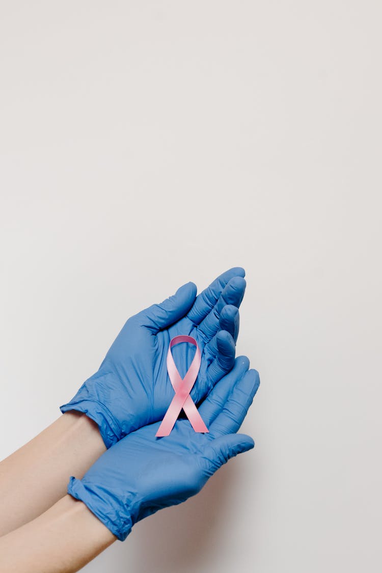 A Person Holding A Cancer Ribbon