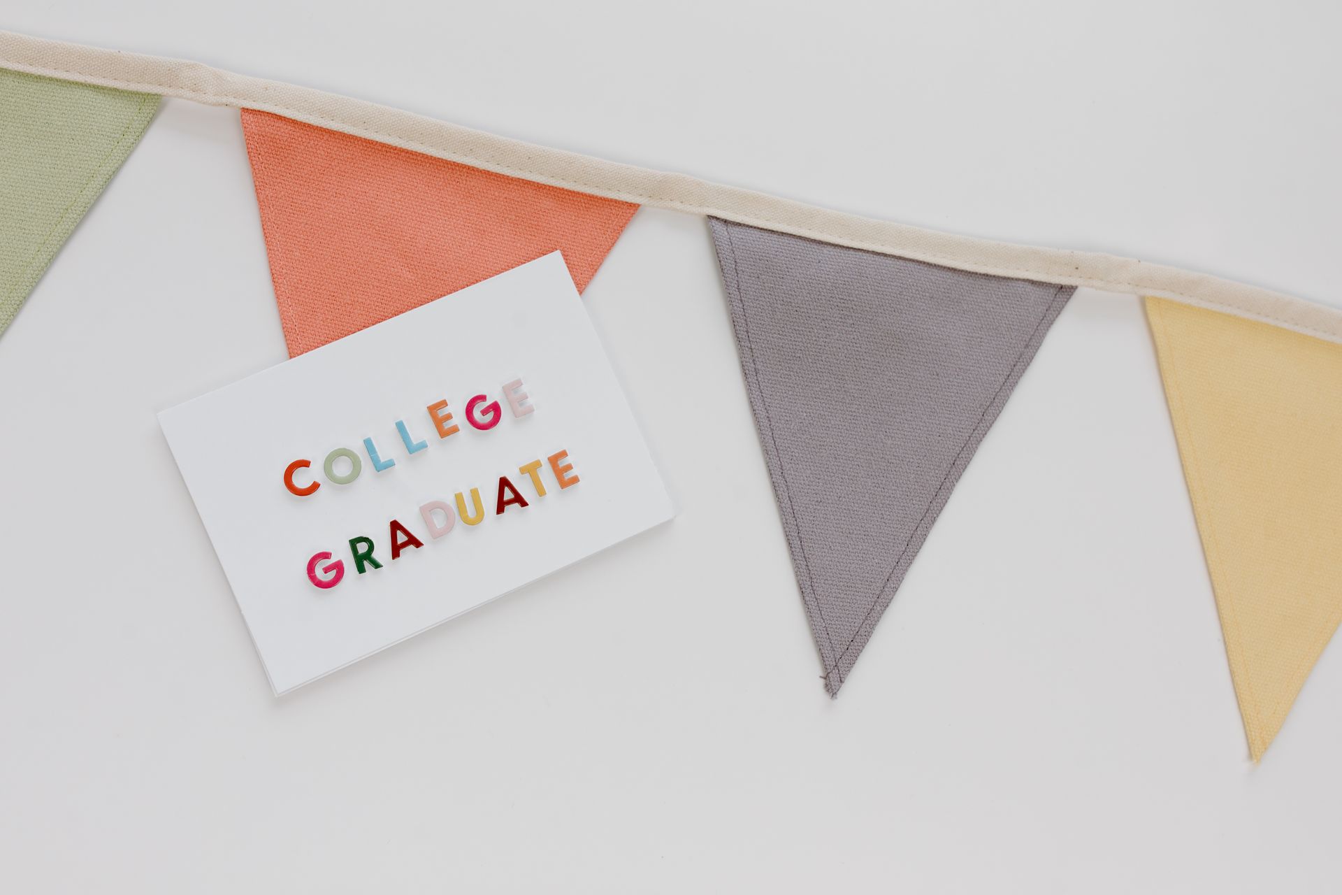 Bright and colorful college graduate card with decorative bunting banners.