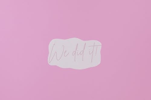 A Paper with We Did It Message on Purple background