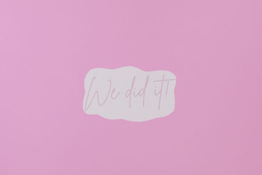 A Paper with We Did It Message on Purple background