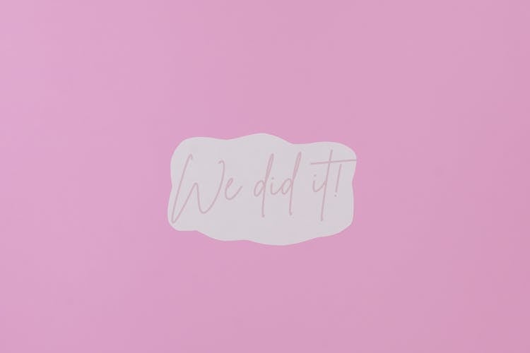 A Paper With We Did It Message On Purple Background