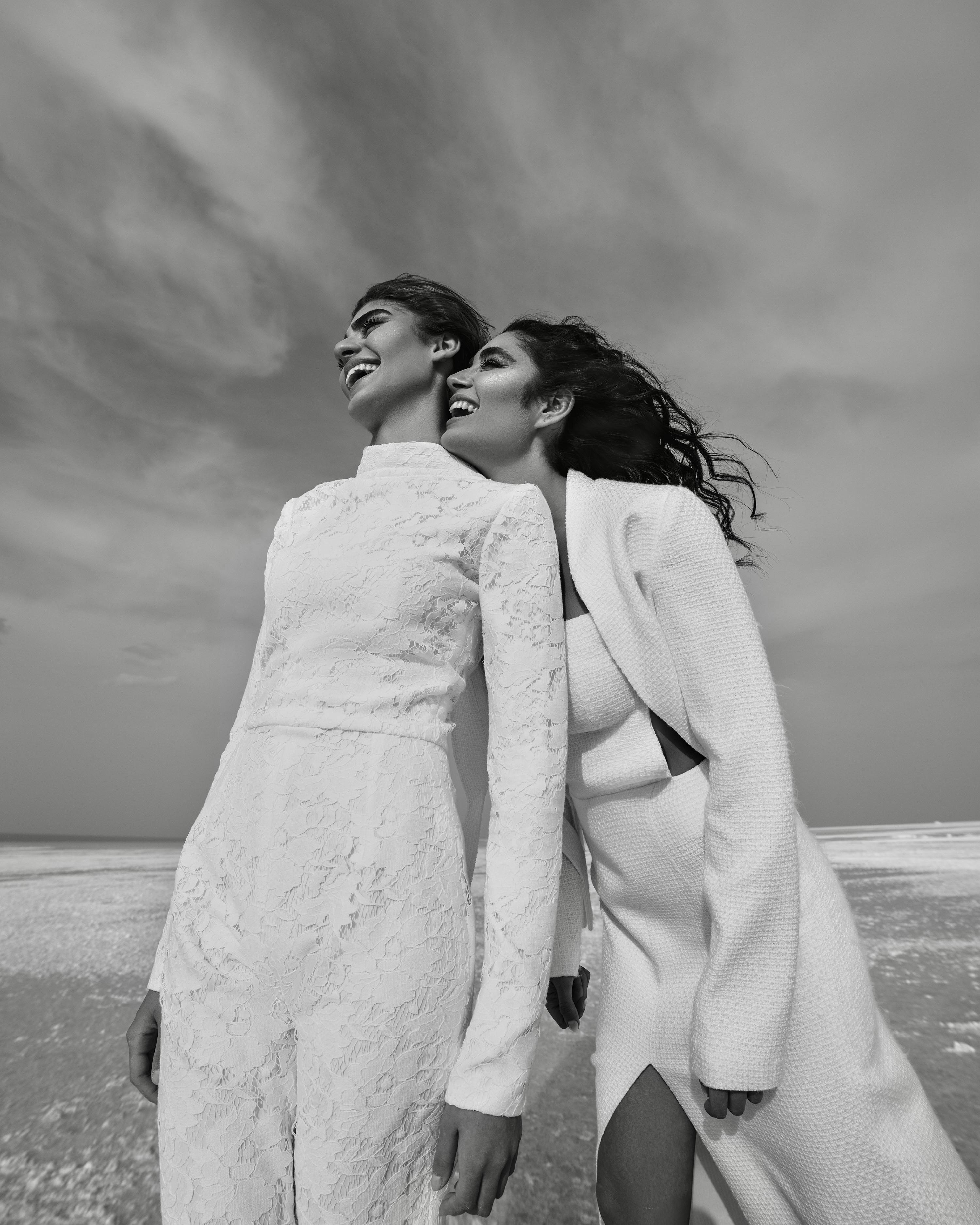 cheerful females in white clothes near sea