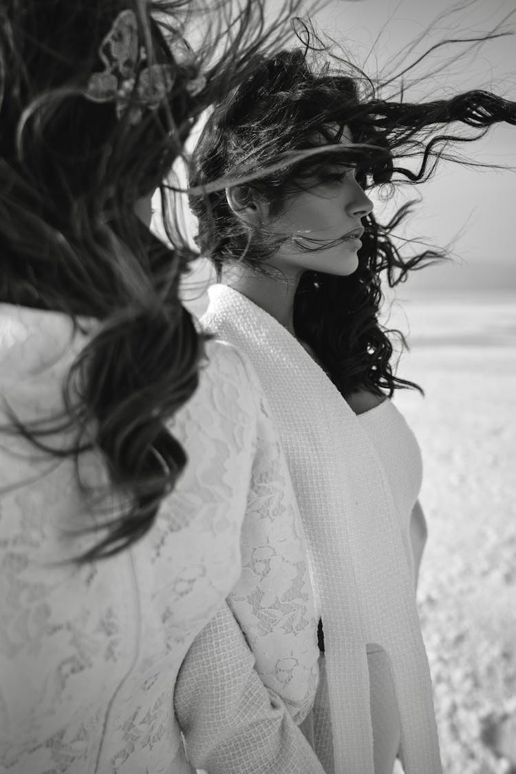 Women With Long Dark Hair Flying In Wind On Beach