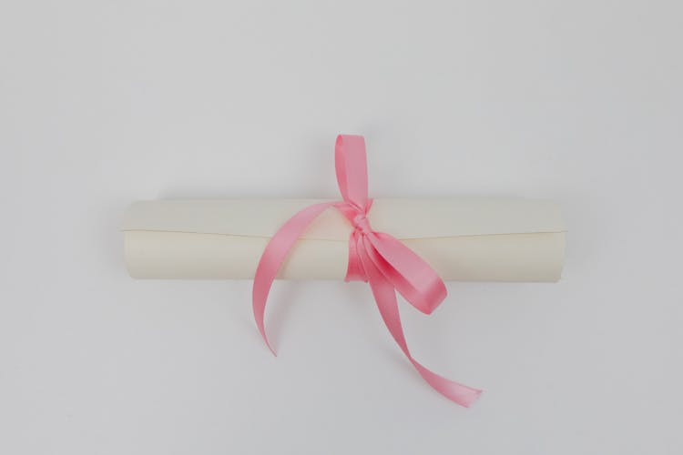White Rolled Paper With Pink Ribbon