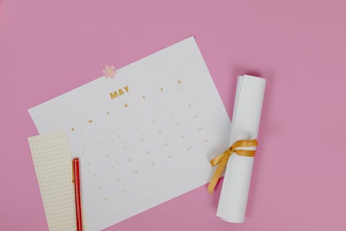 White Calendar on Pink Surface