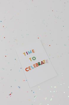 Vibrant 'Time to Celebrate' greeting card surrounded by confetti.