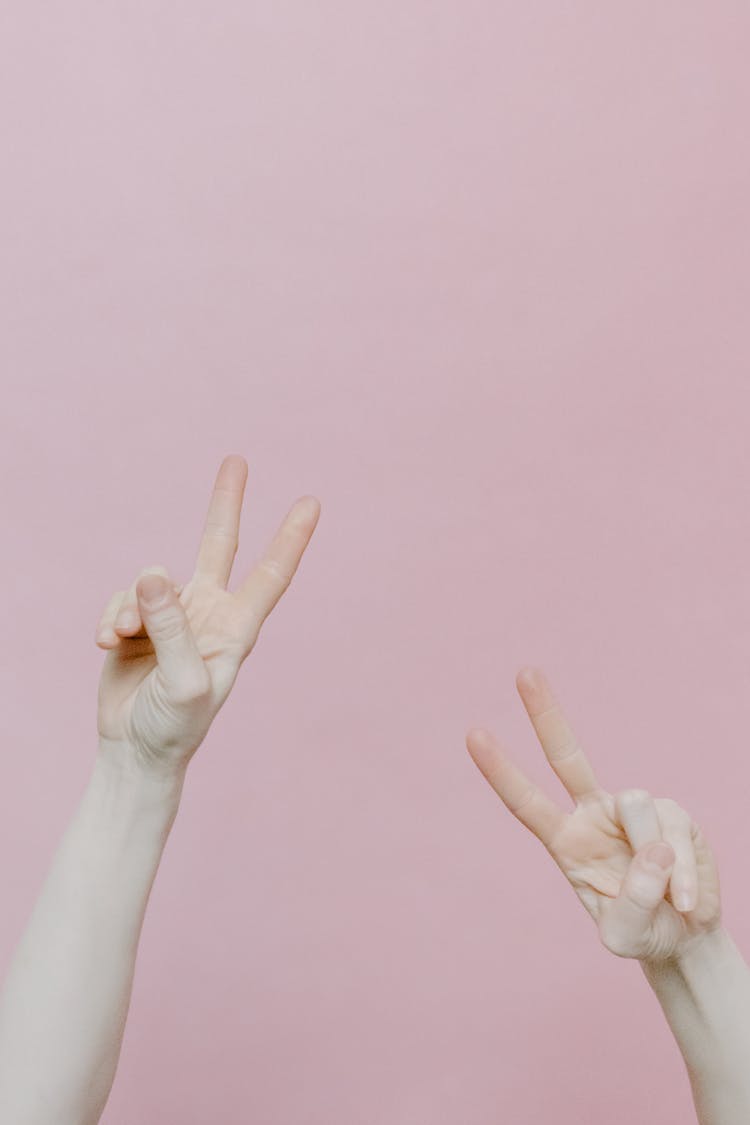 Persons Hands Doing A Peace Sign