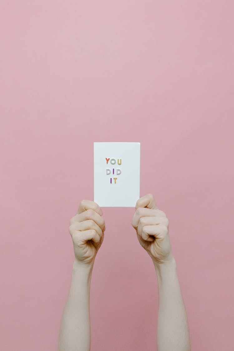 A Person Holding A White Card With A Message You Did It