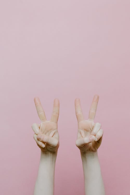 Free Two Hands Forming Peace Sign Stock Photo