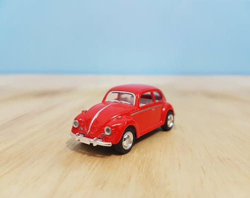 Depth of Field Photography of Red Volkswagen Beetle Diecast Model