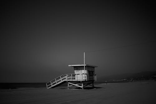 White Wooden Lifeguard House Near Shoreline