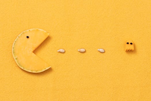 Unique food art piece inspired by Pacman, featuring pumpkin and seeds on a vibrant yellow background.