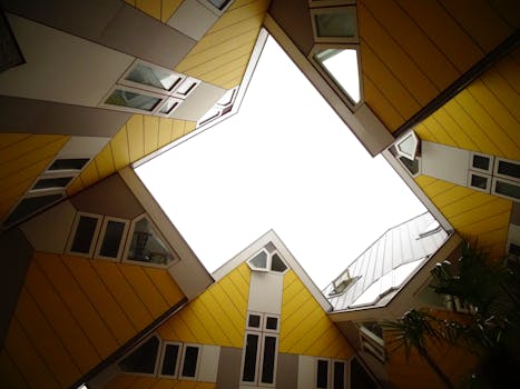 Low angle view of Rotterdam's iconic cube houses, showcasing modern architecture with vibrant yellow panels.