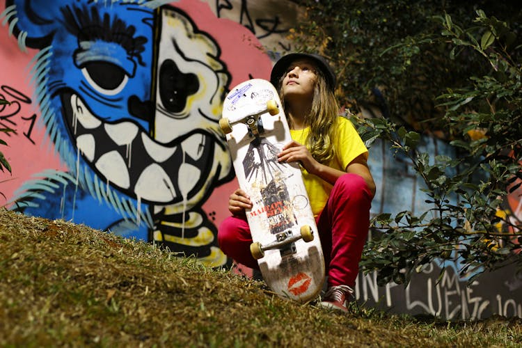 A Girl Holding Her Skateboard