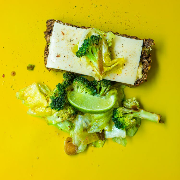 Photo Of Green Broccoli, White Cheese And Green Cabbage On Yellow Surface