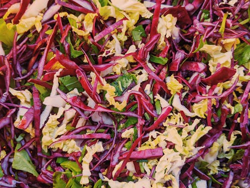 Top view portion of fresh colorful salad with tasty crisp red and Chinese cabbage mixed together with healthy arugula greens