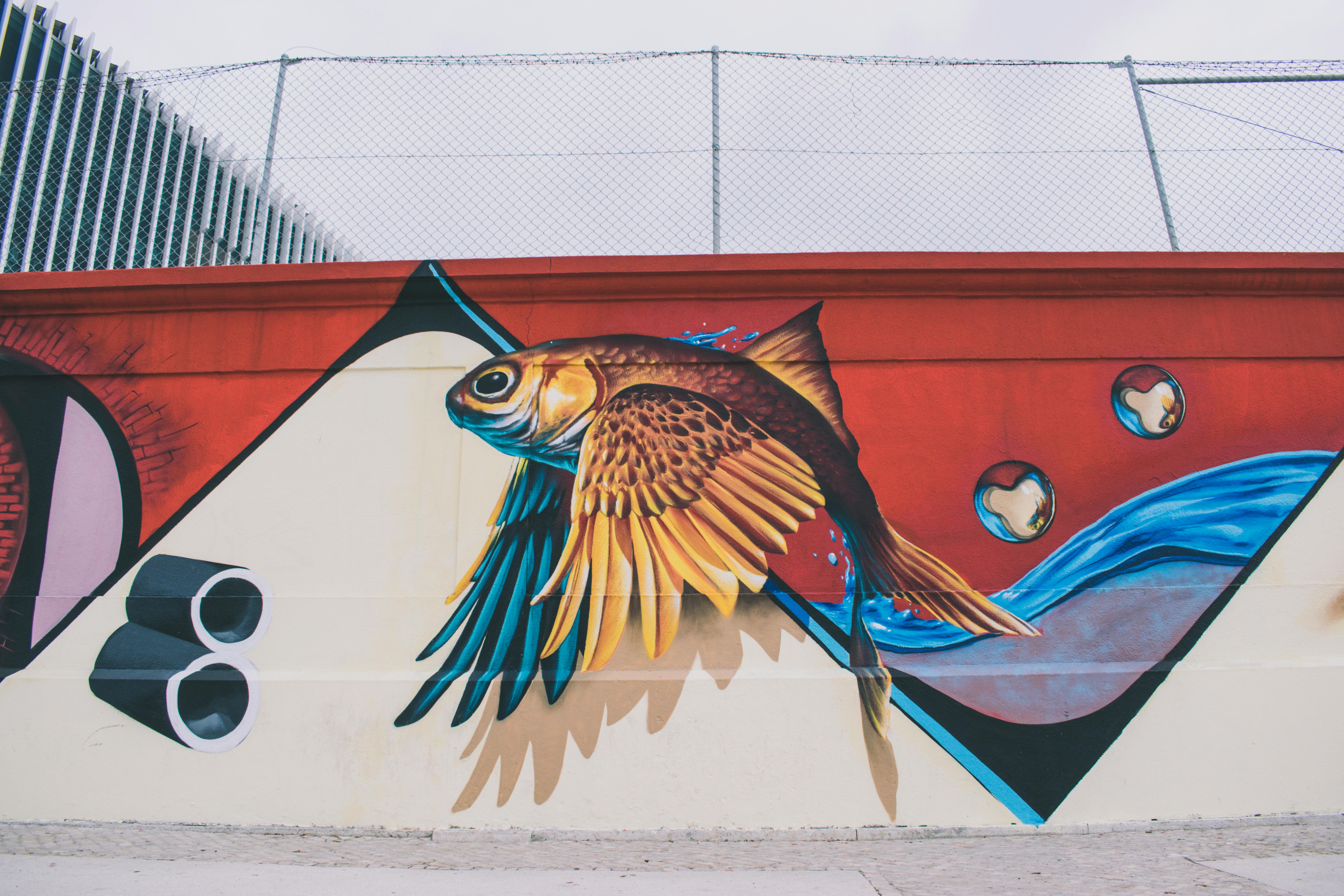 Photo Of Brown Blue Red And White Fish With Wings Wall Painting