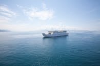 A White Ship Cruising on Sea Under Blue Sky