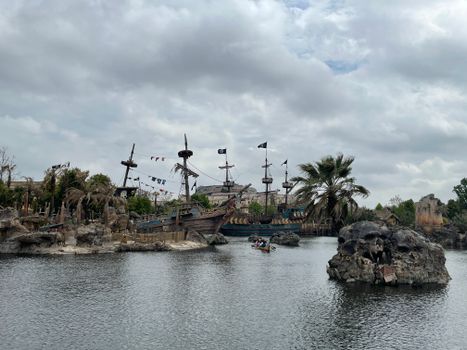 Pirate-themed boats and rocks in a lake setting, showcasing a thrilling adventure vibe.