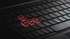 Black Laptop Keyboard with a Few Keys Illuminated by Red Light