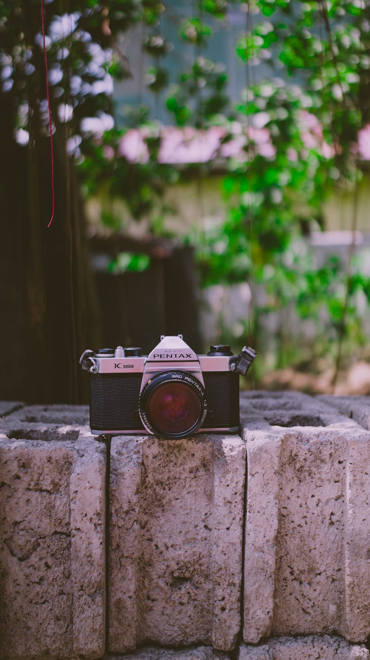 A Black And Silver Camera On Hollow Blocks