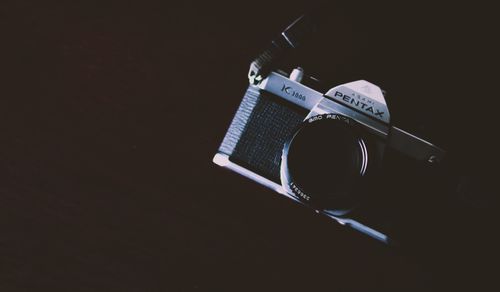 Free Close-up shot of a classic film camera with a dark, moody background. Stock Photo