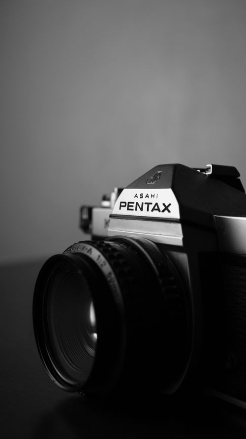 Free Close-up shot of a vintage Pentax camera in black and white, highlighting the classic design. Stock Photo