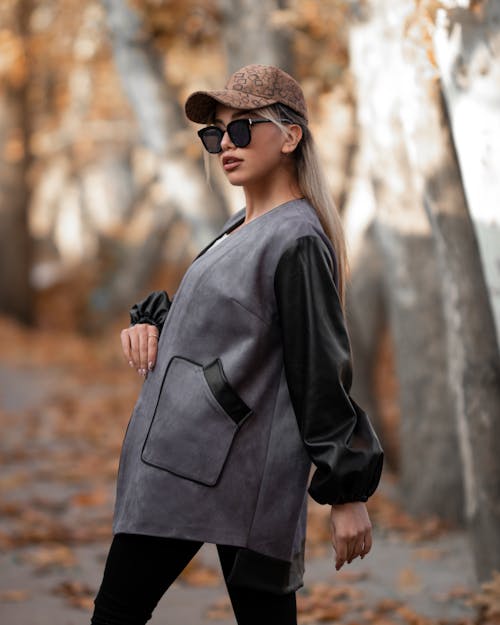 Woman in Wearing Sunglasses and Cap Looking at the Camera