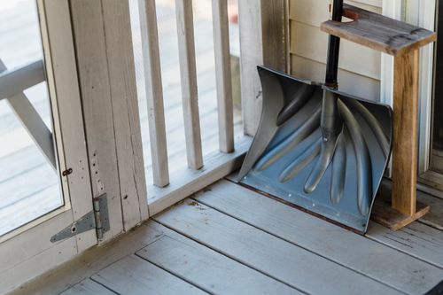 Free From above of wooden shovel with handle placed on floor of terrace near door Stock Photo