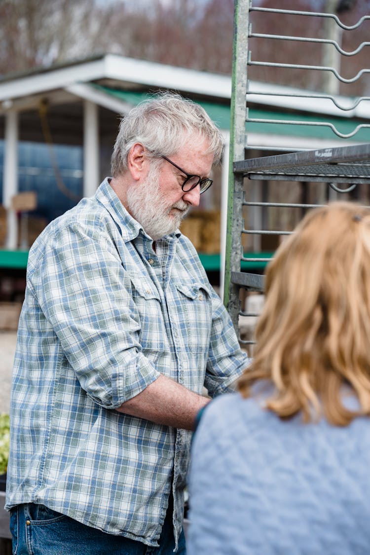 Aged Man Standing In Farm