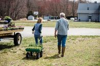 Unrecognizable couple of farmers walking in countryside