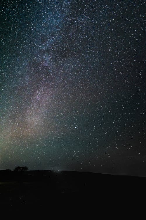 Silhouette of a Mountain under a Starry Night Sky