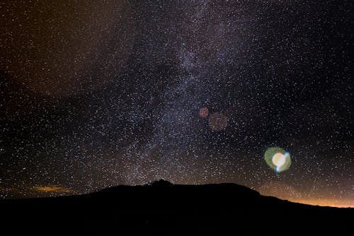 Free Silhouette of a Mountain under a Starry Night Sky Stock Photo