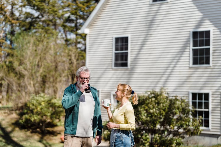 Man And Woman Having Coffee On The Garden